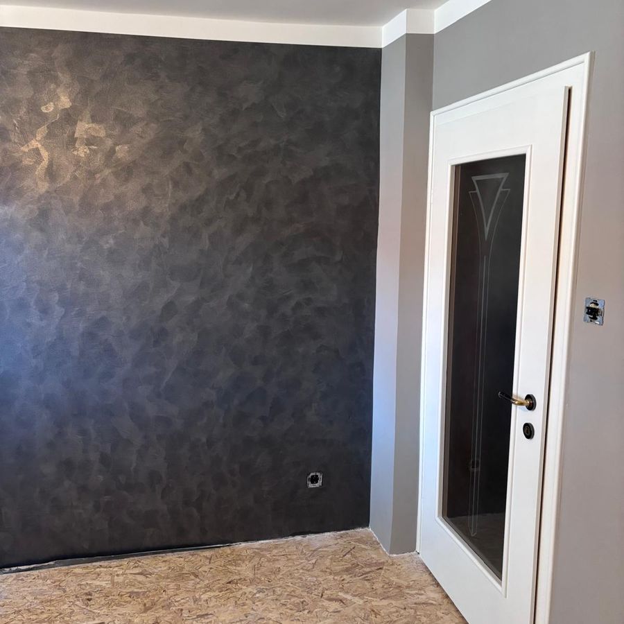 Dunkle Spachteltechnik-Wand mit Metallic-Effekt